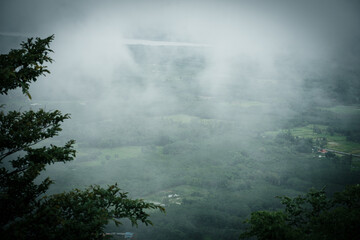 Mysterious fog descends over serene valley nature landscape tranquil environment aerial view enigmatic beauty