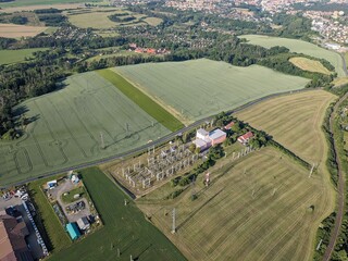 Electric substation aerial view with transformers and high-voltage power lines