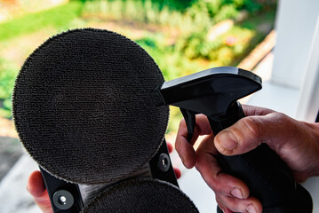 Adding water to the window cleaner robot.