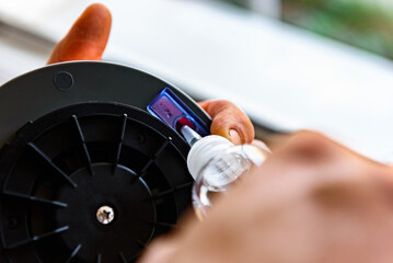 Adding water to the window cleaner robot.