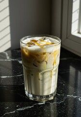 Iced Caramel Coffee Drink in Glass on Marble Table