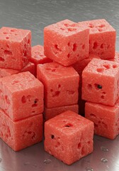Red Watermelon Cubes on Metal Surface
