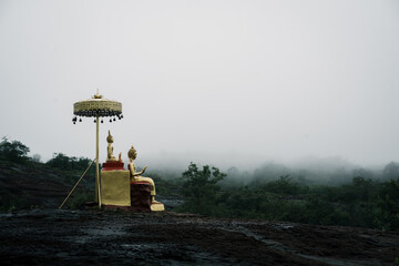 Serene buddha statue amidst misty landscape ancient temple photography tranquil environment wide angle spiritual reflection