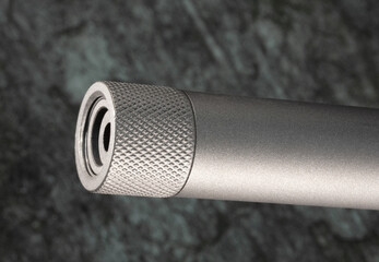 Thread protector on the barrel of a rifle