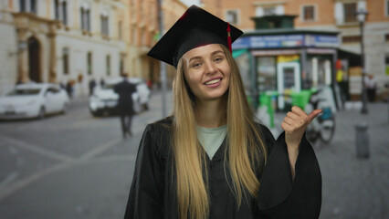 Woman in graduation attire smiles on a busy city street, symbolizing success and achievement in an...
