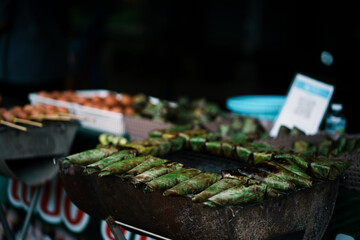 Street food delights grilled delicacies at night market urban setting food photography vibrant atmosphere close-up view