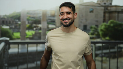 Young man smiling in front of ancient roman ruins, showcasing an attractive and happy persona...