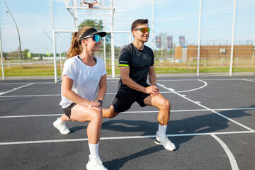 Fitness enthusiasts engaging in lunges at a modern sports facility