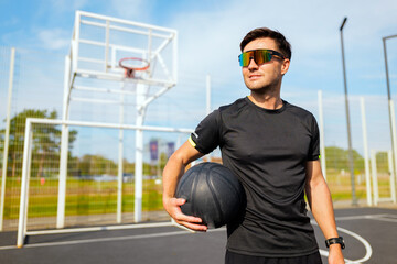 Focused basketball player prepares for practice on outdoor court