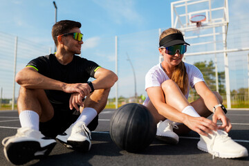 Engaging in friendly basketball talk on a sunny court afternoon