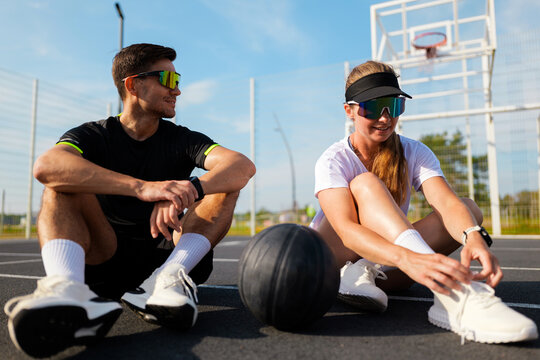 Engaging in friendly basketball talk on a sunny court afternoon - Powered by Adobe