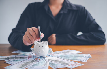 Women put coins in piggy banks ,Money saving and deposit for investment to get profit and dividend concept.
