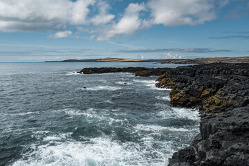 Rocky Coastal Landscape with Waves Crashing on Shore