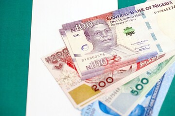 Nigerian naira currency money bills lies on flag. The concept of business and investment