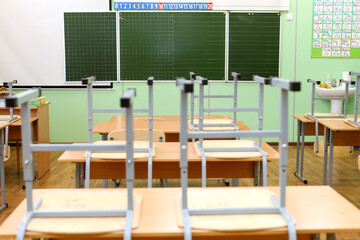 Empty Classroom with Chairs on Desks, Symbolizing the End School Year and New Beginnings.