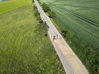 Large tree stump marking road closure before construction of new bridge bypass