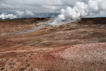 Geothermal Steam Vents in Volcanic Landscape Under Cloudy Sky