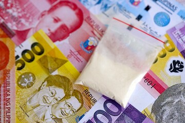 Philippines peso currency money bills and cocaine pack. The concept of drug trafficking
