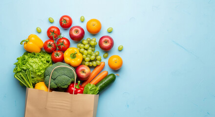 Top view of a paper bag overflowing with fresh produce. Vibrant fruits and vegetables on a blue background