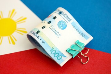 Philippines peso currency money bills lies on flag. The concept of business and investment