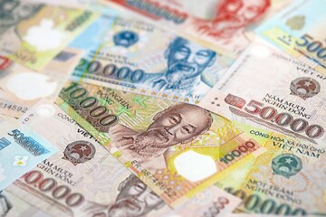 Vietnamese dong currency money bills. The current banknotes lies on table in big amount