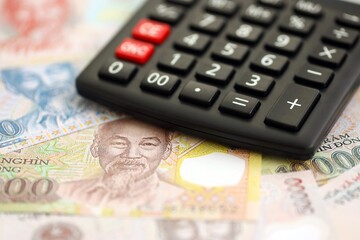 Vietnamese dong currency money bills and calculator. The concept of taxation and money count