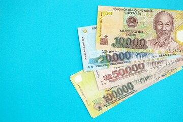 Vietnamese dong money bills in big amount on blue. Finance and banking concept