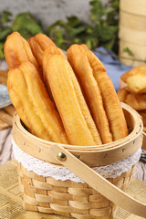 Crispy fritters fried to perfection, served fresh in a woven basket for a delightful treat