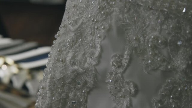 A close up of a wedding dress, which highlights the finer details.