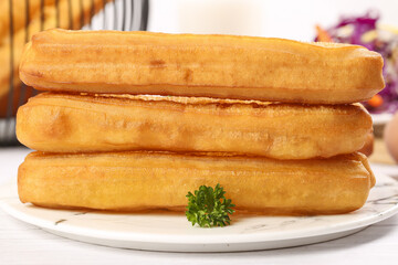 Crispy dumplings stacked on a plate, ready to enjoy for breakfast in a cozy setting