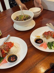 steamed rice topped with chicken On the table