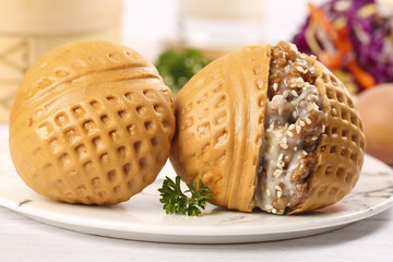 Canton style walnut buns filled with brown sugar served on a table in a cozy dining setting