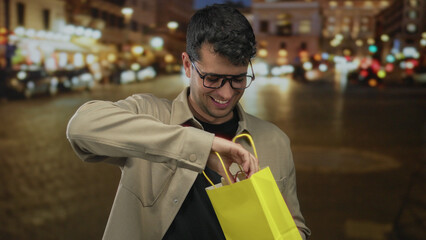 Man carries a gift bag before reaching toward merchandise near street vendor as male shopper, guy...