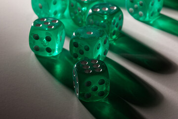 A random arrangement of green dice and a puzzle cup, captured after the dice have been cast.