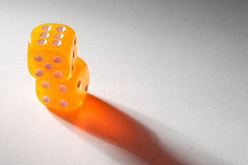 A random arrangement of yellow dice and a puzzle cup, captured after the dice have been cast.