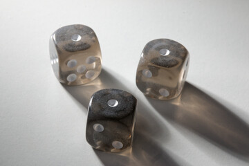 A random arrangement of gray dice and a puzzle cup, captured after the dice have been cast.