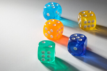 A random arrangement of multicolored dice, captured after the dices have been cast.