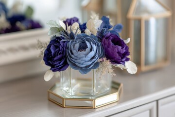 Beautiful decorative floral arrangement in a glass vase showcasing shades of blue and purple