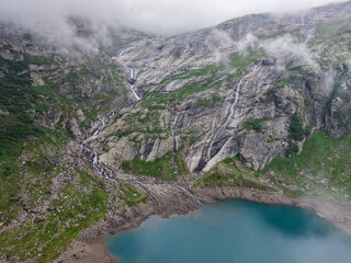 Drone view at dam and lake Zott near Robiei in the Swiss alps