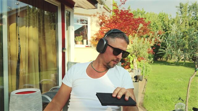 Man switching gaze from tablet to wristwatch