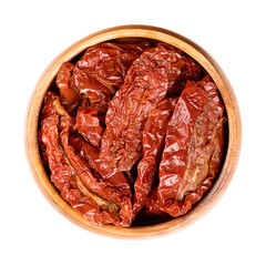 Sun-dried tomatoes, antipasto in a wooden bowl. Whole tomatoes, air dried under the Italian sun, treated with sea salt for preservation. Close-up, from above, isolated on white background, food photo.