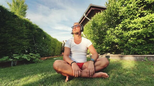 Man enjoying music while seated in backyard