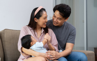 A loving parent embraces their infant, sharing warmth and innocence in a moment of deep connection. This happy family cherishes parenthood, strengthening their relationship through beauty of parenting