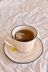 Cup of hot chamomile tea with tea bag. Herbal remedy for calm and wellness.