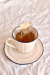 Chamomile tea bag brewing in a cup. Concept of natural healing, relaxation, and herbal medicine.

