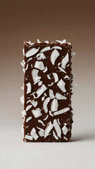Chocolate coconut bar with fresh shredded coconut flakes close up perfect for healthy eating and dessert themed content and advertising