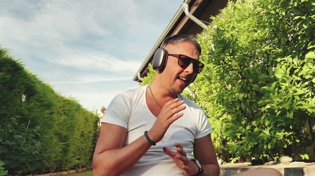 Man sitting and moving rhythmically outdoors