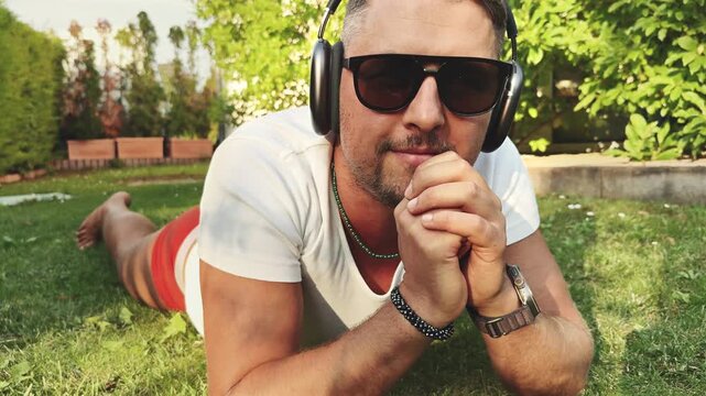 Close-Up of Man Lying in Garden with Headphones