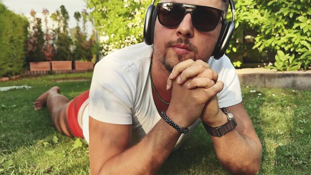 Man Resting on Elbows in Garden at Sunset