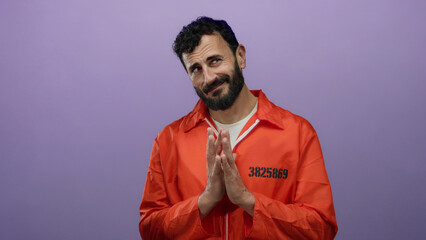 Hispanic man in an orange prison jumpsuit poses with a satisfied expression against a purple background, embodying themes of justice and incarceration.